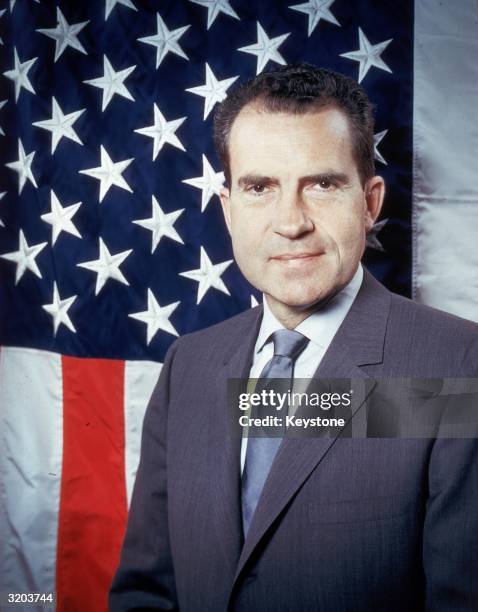 Republican presidential candidate Vice-President Richard Nixon posing in front of the stars and stripes.