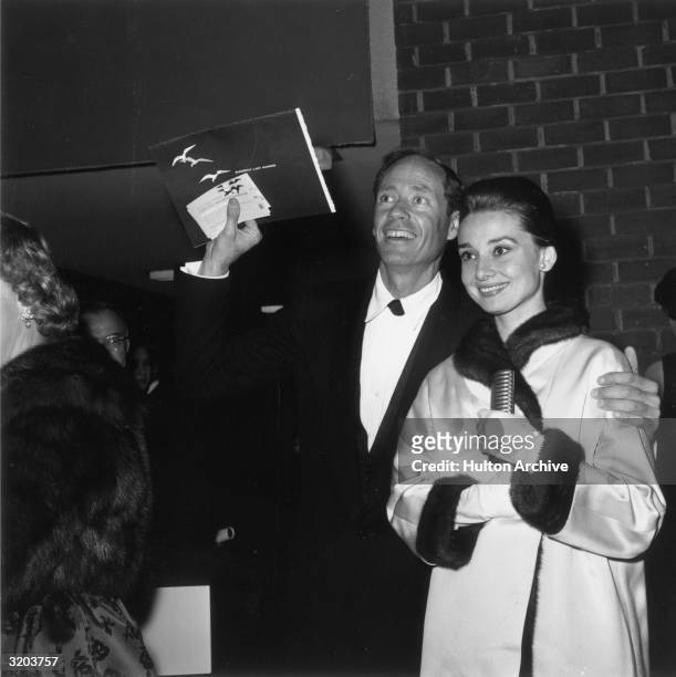 Belgian-born actor Audrey Hepburn and her husband, American actor Mel Ferrer, smile at the premiere of director Joseph L. Mankiewicz's film,...