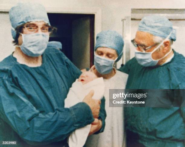 The team who pioneered in-vitro fertilization, on the left Cambridge physiologist Dr Robert Edwards holding the world's first test tube baby Louise...