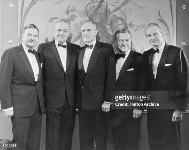 The five Rockefeller brothers posing together in front of a mural at an awards ceremony in New York, during which each received a gold medal for...