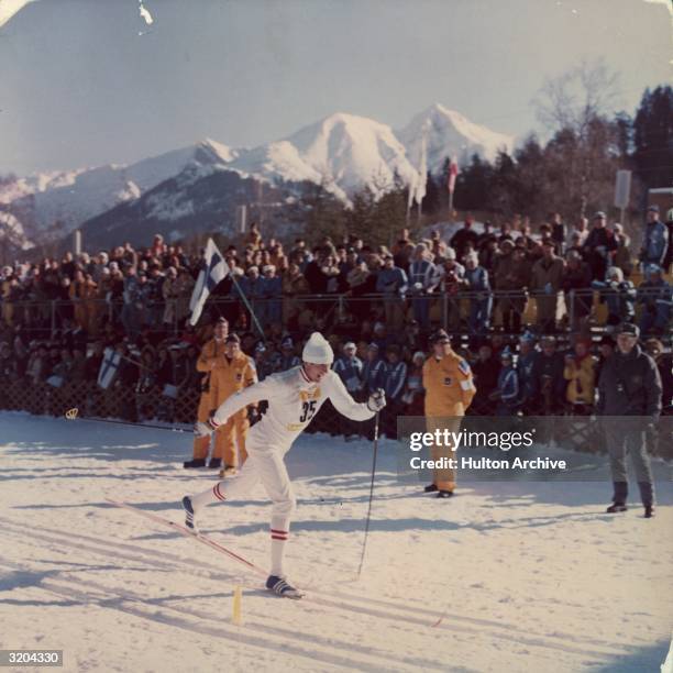 Soviet cross-country skier Sergey Savelyev passes crowds during a men's 30km race at the Winter Olympic Games, Innsbruck, Austria. Saveljev won the...