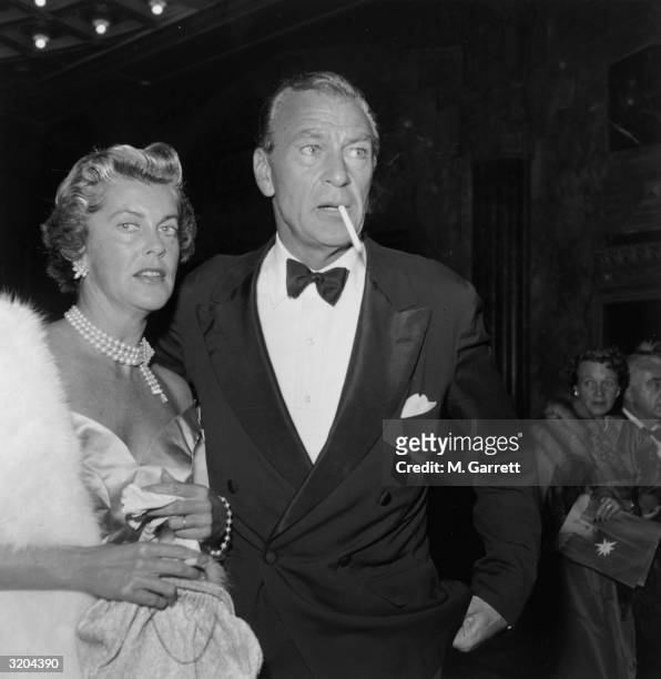American actor Gary Cooper and his wife, Sandra Shaw , attend the premiere of director George Cukor's film, 'A Star is Born,' Hollywood, California....