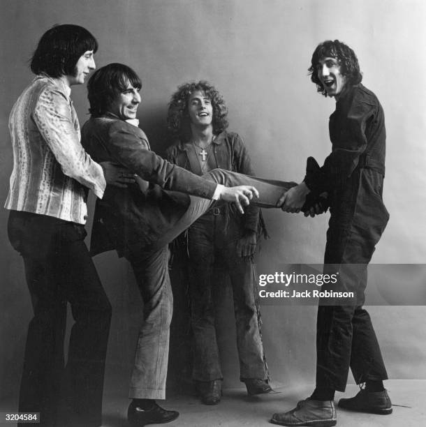 Bassist John Entwistle , drummer Keith Moon , singer Roger Daltrey, and guitarist Pete Townshend, of the British rock group The Who, clown around for...