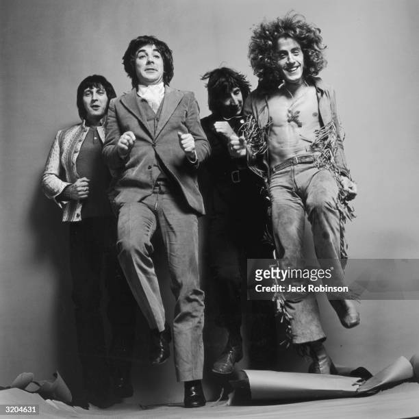 Bassist John Entwistle , drummer Keith Moon , guitarist Pete Townshend and singer Roger Daltrey of the British rock group The Who run in place for a...