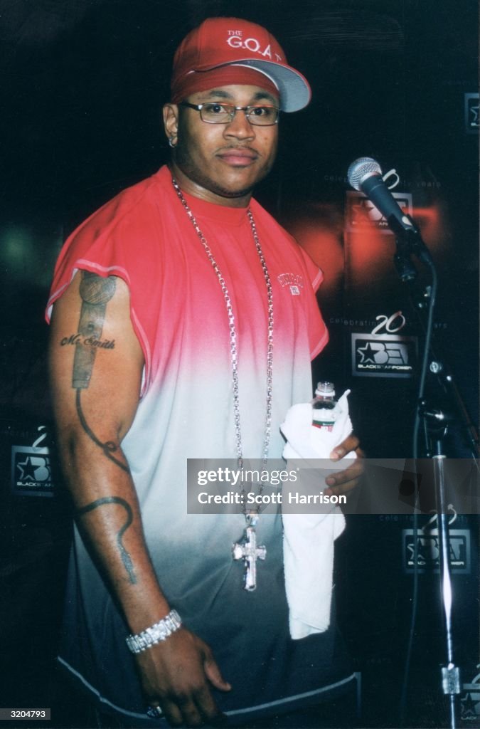 American rapper LL Cool J stands on stage in front of a microphone ...