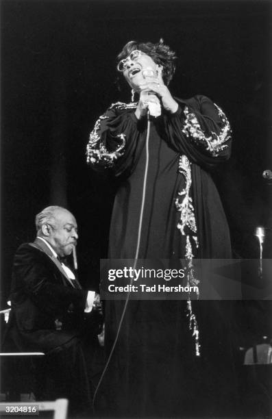 American jazz pianist, composer and bandleader Count Basie performs with American jazz singer Ella Fitzgerald during a concert at the San Antonio...