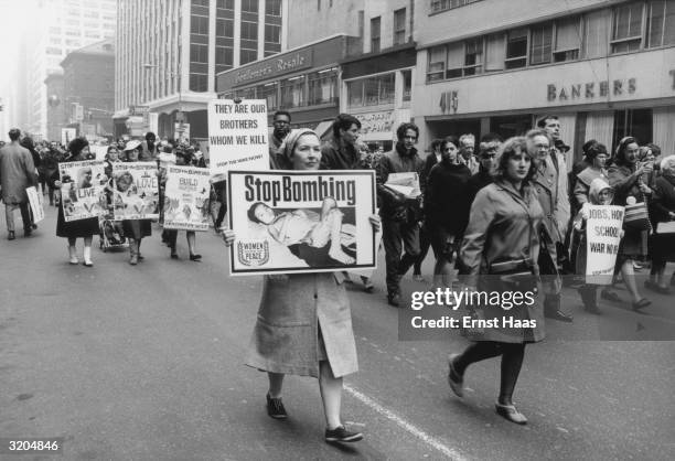 Marchers at an anti-Vietnam demonstration in New York carry placards demanding the end of the bombing.