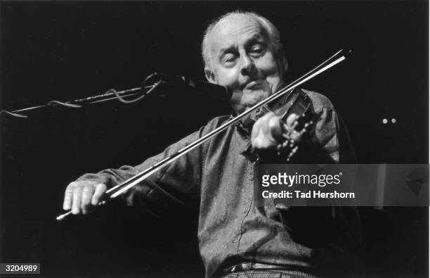 French jazz musician Stephane Grappelli plays a violin on stage for Da Camera Society at the Wurtham Theater in Houston, Texas.