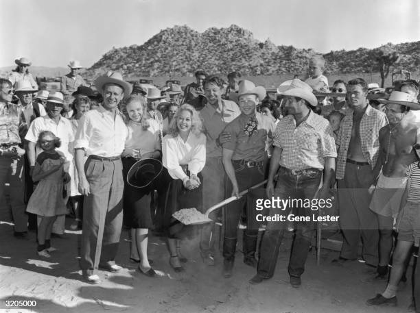 The musical group Sons of the Pioneers : David Bruce, Sally Patten, Adele Mara, unknown man, Roy Rogers , and George Tobias. Rogers is holding a...