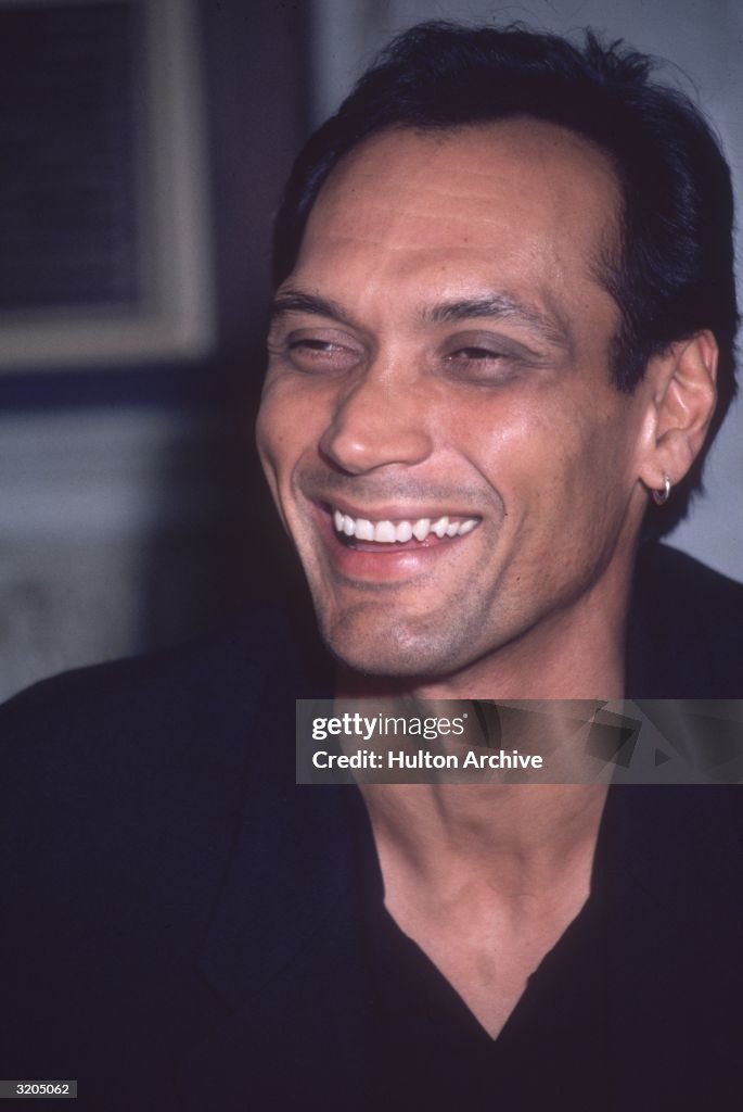 Headshot of American actor Jimmy Smits laughing, wearing an... News