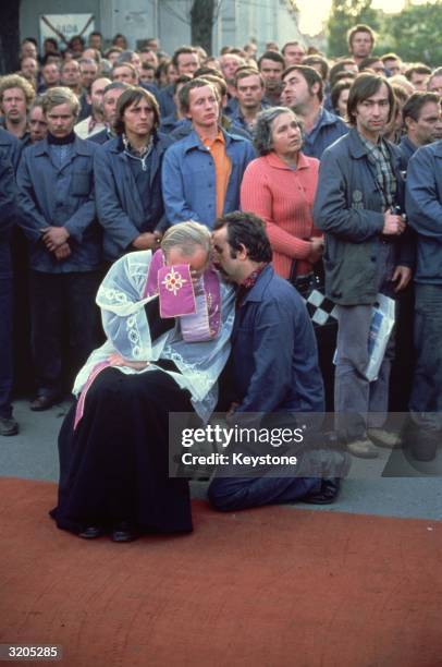 Member of the Trade Union, Solidarity, who are on strike at the Lenin Shipyard in Gdansk, receives a blessing from a priest of the Catholic Church....