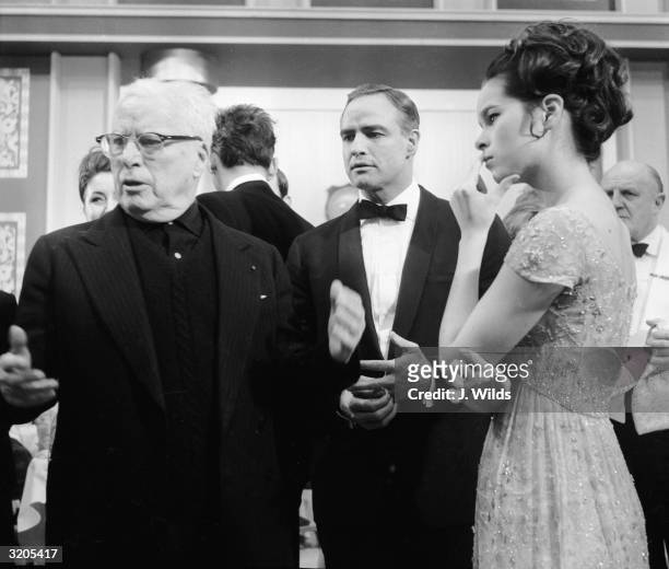 British comic actor and director Charlie Chaplin directs Marlon Brando and his daughter Geraldine Chaplin on the set of 'The Countess From Hong Kong'.