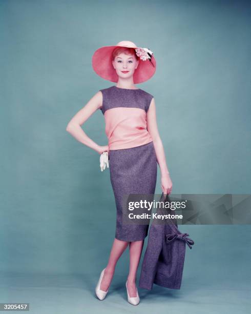 Woman modelling a day dress and sunhat as part of the new Dior collection.