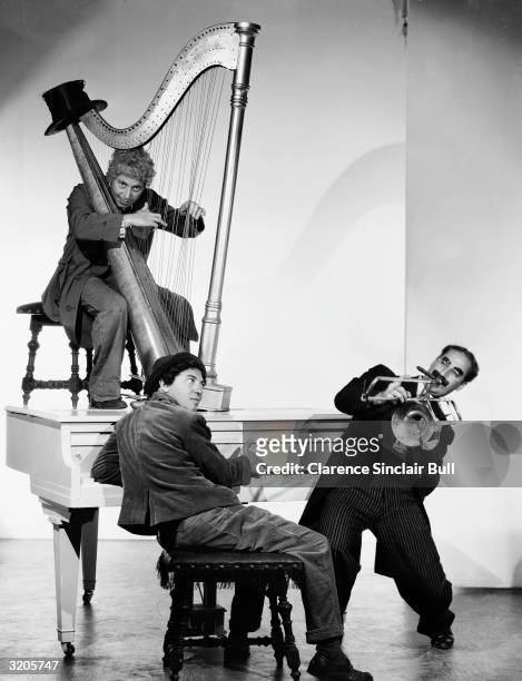 Three of the Marx Brothers Harpo , Chico and Groucho as an unconventional trio in a publicity shot for their film 'A Night At The Opera', directed by...