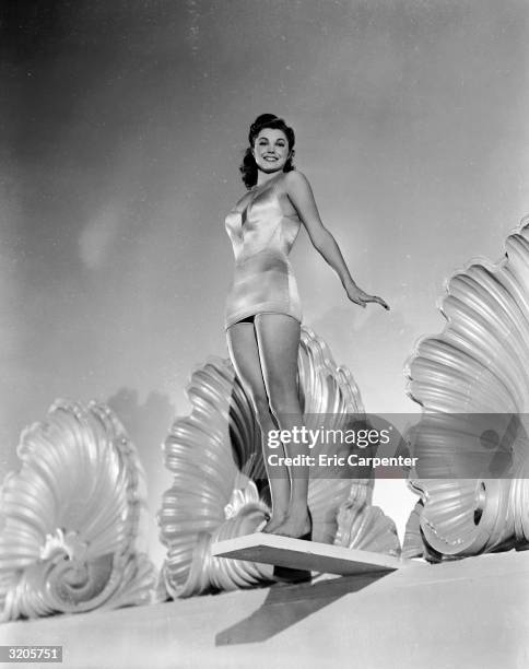 Former swimming champion and Hollywood film star, Esther Williams prepares to take a dive.