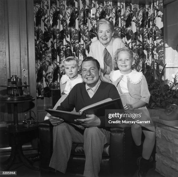 American actor and bandleader Phil Harris poses with his wife, American actor and singer Alice Faye, and their two daughters, Alice and Phyllis,...