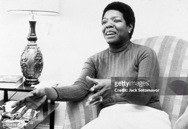 American poet and author Maya Angelou gestures while speaking in a chair during an interview at her home.