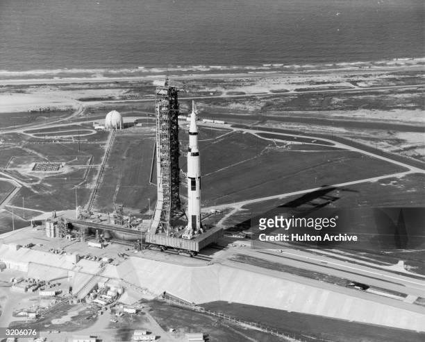 View of the Apollo 11 rocket standing with its gantry on the launch pad at Kennedy Space Center, Cape Canaveral, Florida. The rocket served the first...