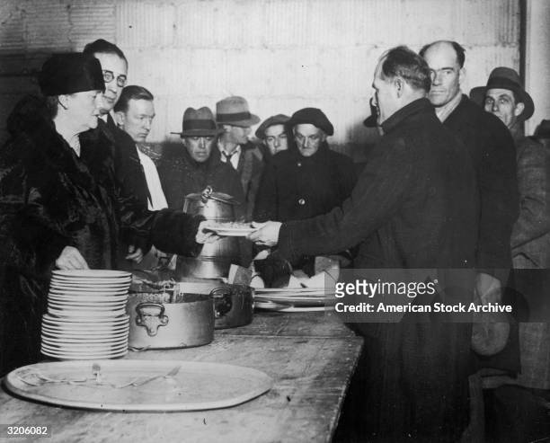 Dolly Gann , sister of U.S. Vice president Charles Curtis, helps serve meals to the hungry at a Salvation Army soup kitchen during the Great...