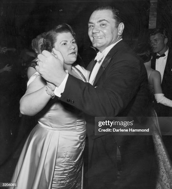 American actor Ernest Borgnine smiles as he dances with his first wife, Rhoda, at an Oscar party for director Delbert Mann's film, 'Marty,' Beverly...