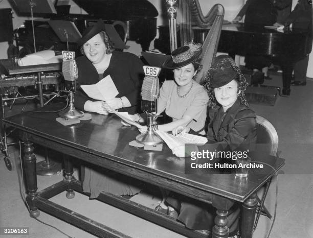 American vocalist Kate Smith sits at a table with Mrs. Pat O'Brien and Mrs. James Cagney, who were guests on Smith's CBS radio program, 'Kate Smith...