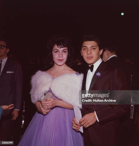 American actors Annette Funicello and Paul Anka. Both wear buttons which read, 'KHJ Radio 93 Salutes Elvis.' Funicello wears a lavender pleated dress...