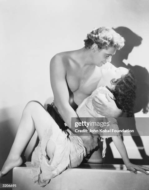 Johnny Weissmuller and Maureen O'Sullivan embracing in a scene from W S Van Dyke's film 'Tarzan The Ape Man', the first of nineteen Tarzan movies to...