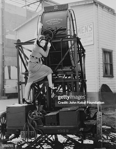 Young starlet clambering on a large floodlight at the MGM studio lot in Culver City, California, 17th January 1931. The winch is in front of the...