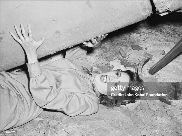 Kay Aldridge narrowly escapes being crushed by a falling pillar in 'Perils of Nyoka', directed by William Witney.