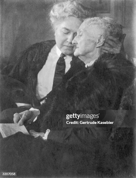 Middle-aged woman, wearing a shirt and tie, cradles the head of her elderly mother while they sit together. Entitled 'Mother', the photograph was...