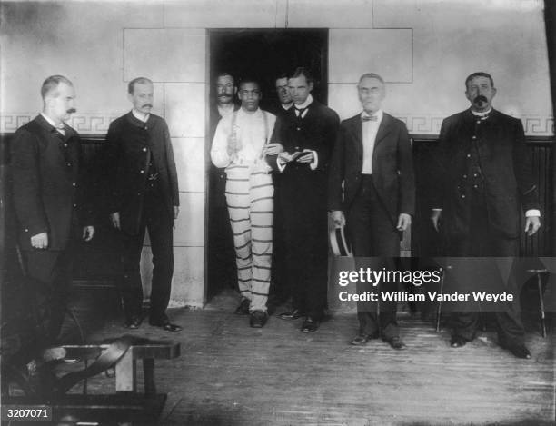 Caucasian priest leads African-American man to electric chair, Sing Sing prison, Ossining, New York.