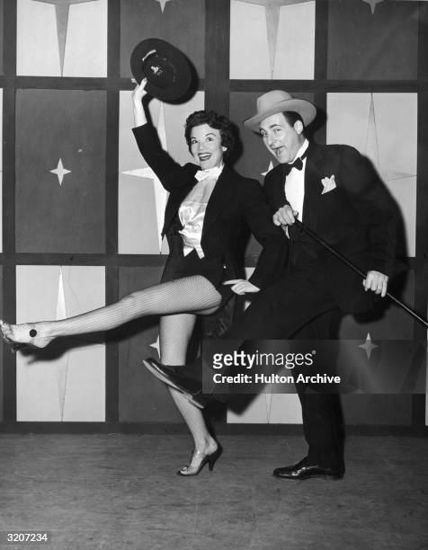 Full-length image of American actors Nanette Fabray and Sid Caesar dancing in a still from the television comedy series, 'Caesar's Hour'. Fabray...