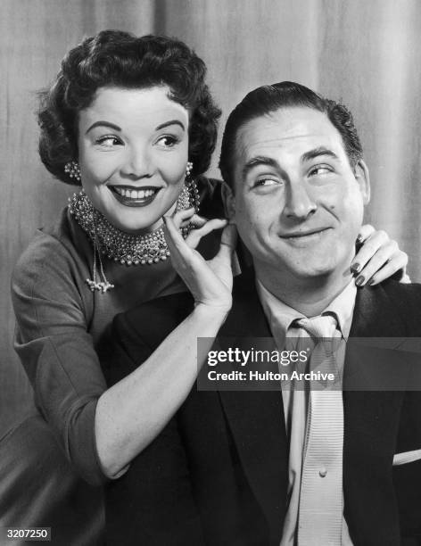 American actor Nanette Fabray smiles while tugging at the earlobe of American comedian Sid Caesar in a promotional portrait for the television...