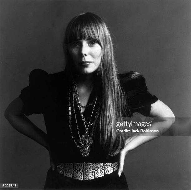 Portrait of American musician Joni Mitchell with her hands on her hips. This image was from a photo shoot for the fashion magazine Vogue. Mitchell...