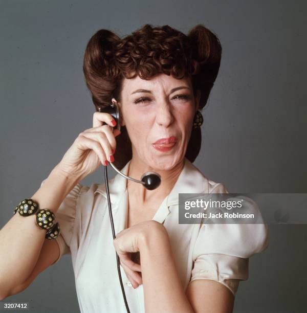 Studio portrait of American comedian and actor Lily Tomlin in costume as a switchboard operator from the television series, 'Laugh-In'.