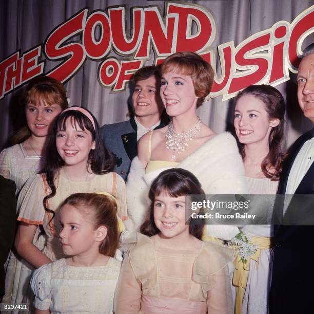 British actor and singer Julie Andrews poses with other cast members of director Robert Wise's film, 'The Sound of Music,' at the film's premiere,...