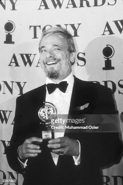 American composer and lyricist Stephen Sondheim poses with his Best Original Score Tony Award, for 'Passion,' in front of the event logo at the Tony...