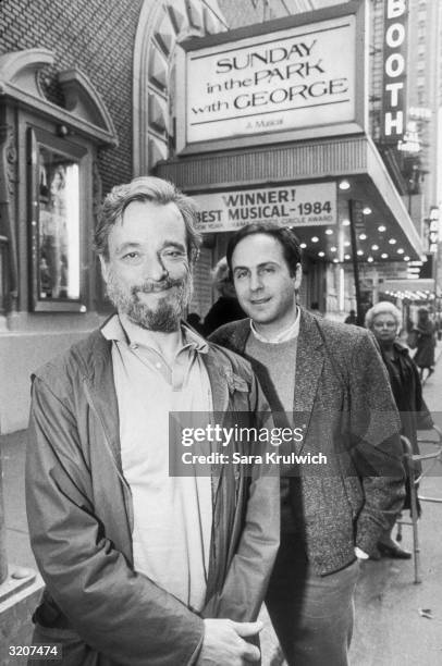 American composer Stephen Sondheim and playwright James Lapine pose in front of the marquee of the Booth Theatre on 45th Street, New York City. They...