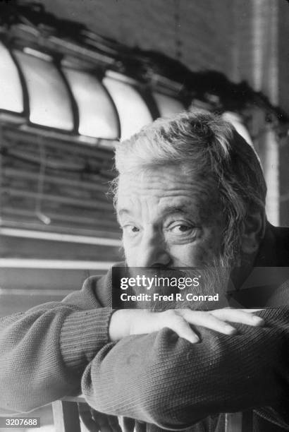 Headshot portrait of American composer and lyricist Stephen Sondheim, resting his chin on his arms, backstage at the Plymouth Theater, New York City....