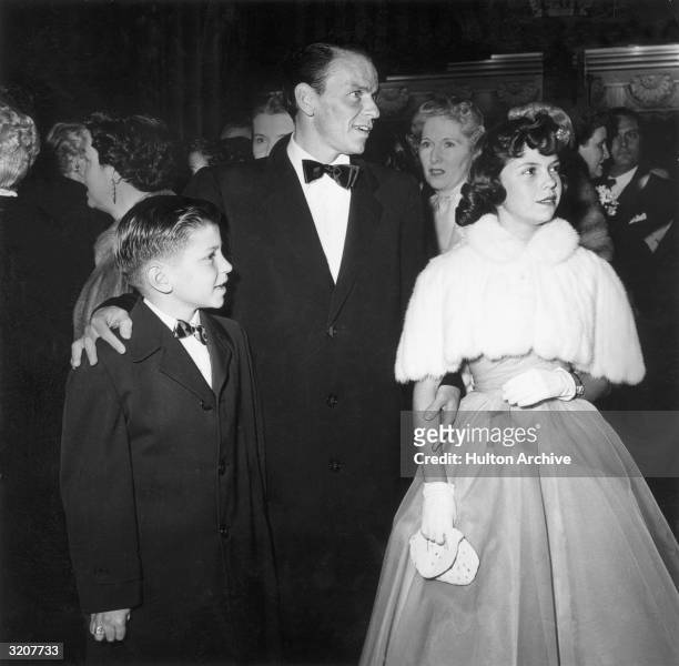 American actor and singer Frank Sinatra with his son, Frank, Jr. And daughter, Nancy, at the Academy Awards at the RKO Pantages Theatre, New York...