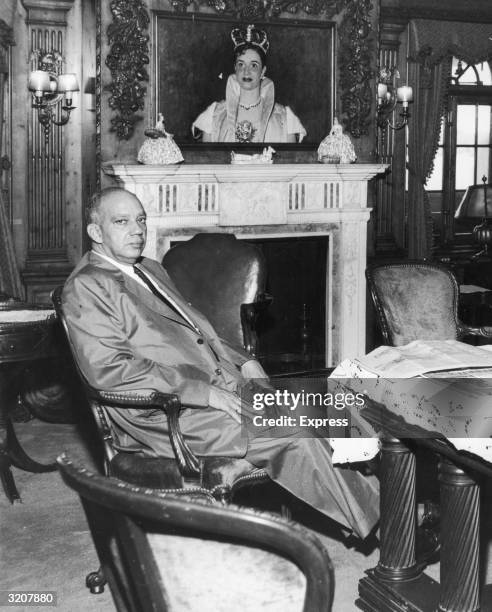 Portrait of Hector Trujillo, former president of the Dominican Republic, sitting at a table in front of the fireplace in the living room aboard his...