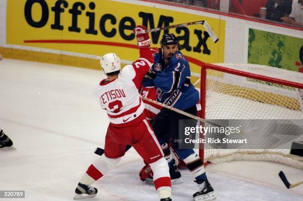 Craig Berube of the Washington Capitals and Viacheslav Fetisov of the Detroit Red Wings fight for position during a Stanley Cup Finals game at the...
