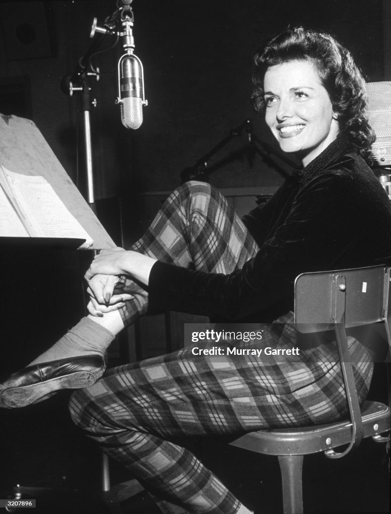 Jane Roussel American actor Jane Russell looks over her shoulder and smiles while ...