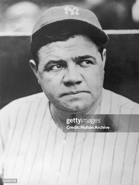 Headshot of American baseball player Babe Ruth wearing his New York Yankees uniform and cap.