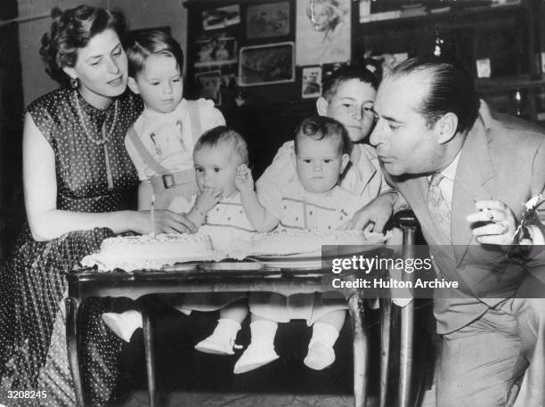 Swedish-born actor Ingrid Bergman and Italian film director Roberto Rossellini celebrate the first birthday of their twin daughters, Isabella and...