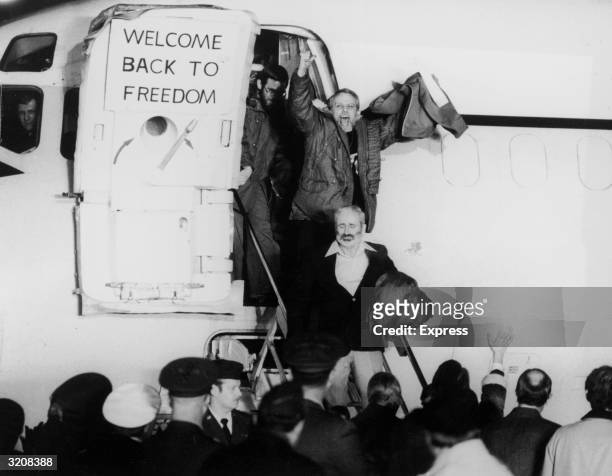 United States hostages departing an airplane on their return from Iran after being held for 444 days. One of the hostages is waving his fists in the...