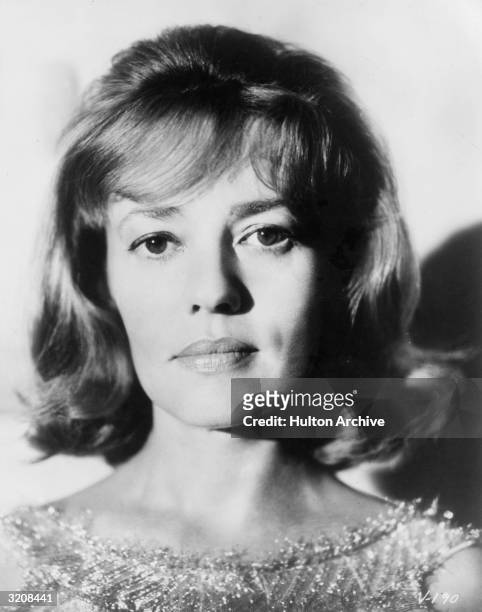 Headshot of French actor Jeanne Moreau wearing a sleeveless metallic blouse.