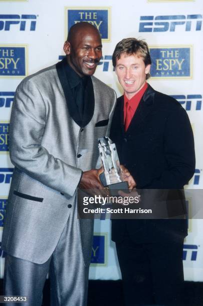 American former basketball player Michael Jordan and Canadian former hockey player Wayne Gretzky hold one of Jordan's awards at the eighth annual...