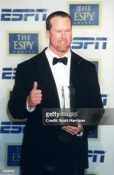St. Louis Cardinals first baseman Mark McGwire gives the thumbs-up sign as he holds his award for Baseball Performer of the Decade at the eighth...