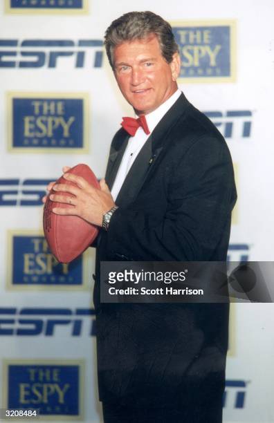 Football analyst and former football player Joe Theismann poses with a football at the eighth annual ESPY Awards, MGM Grand Hotel, Las Vegas, Nevada....